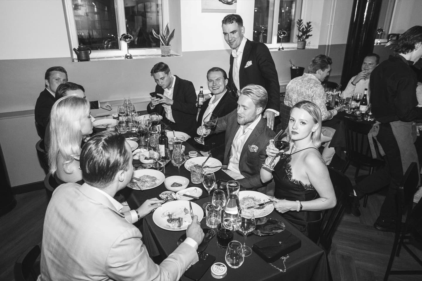 Guests seated together around a dinner table at an Edna Social Club evening in Helsinki