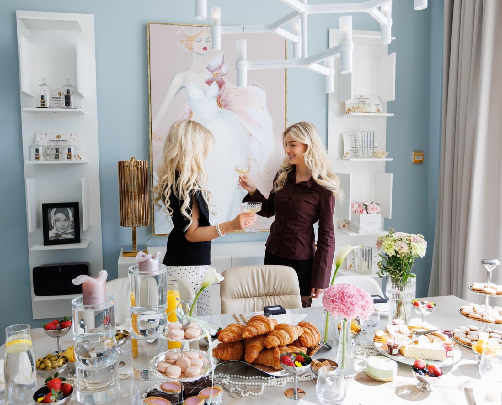 Guests raising champagne glasses beside a beautifully prepared brunch table