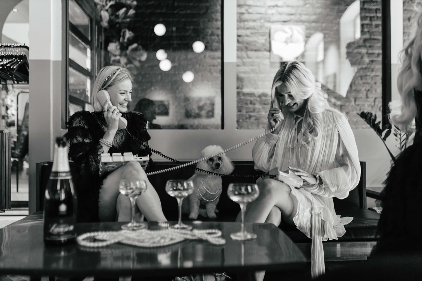 Two guests sharing a playful retro telephone moment at an Edna event